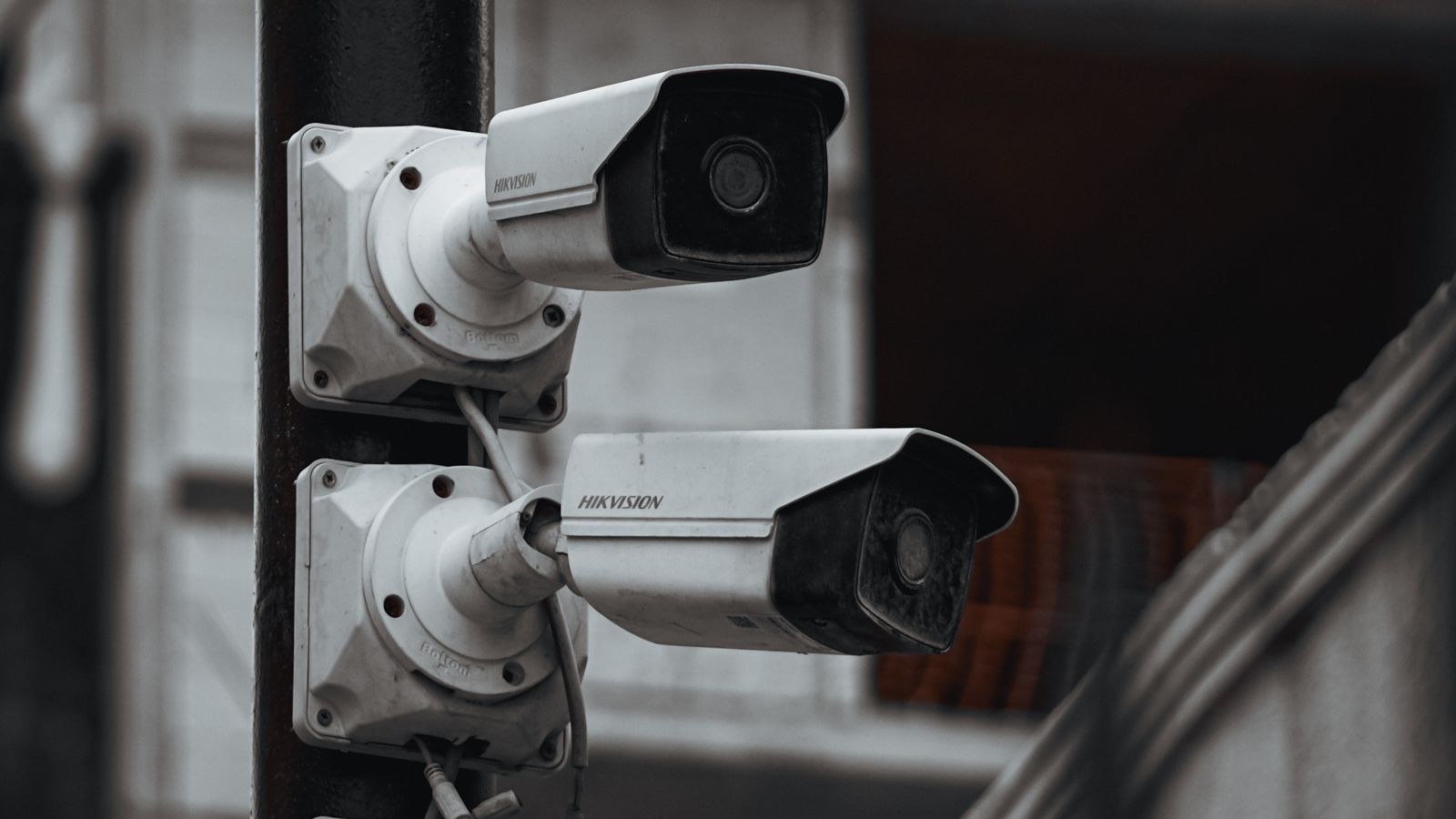 Outdoor CCTV camera on a building wall exposed to sun and weather