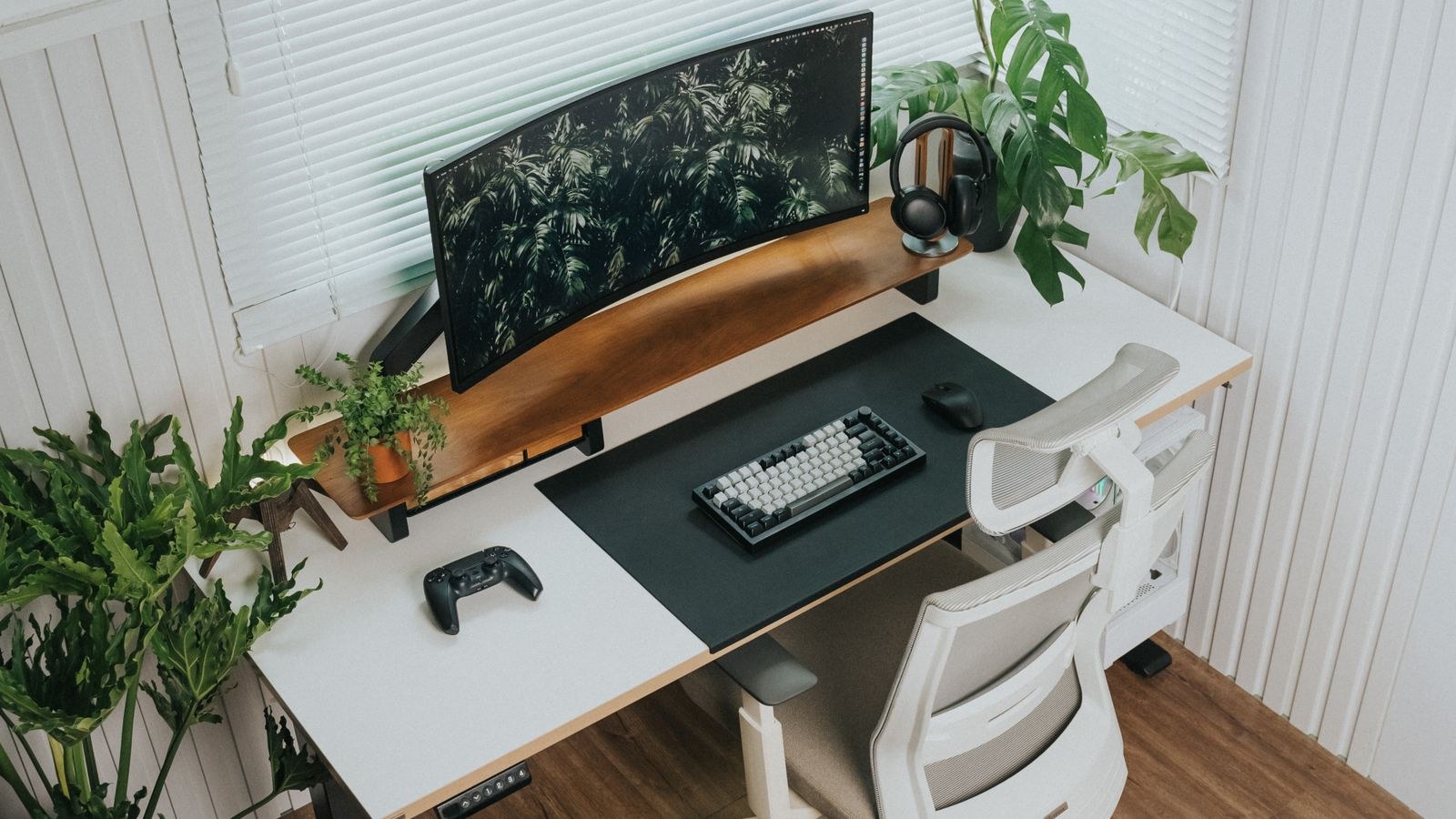 Ergonomic home office with adjustable desk, monitor and plants