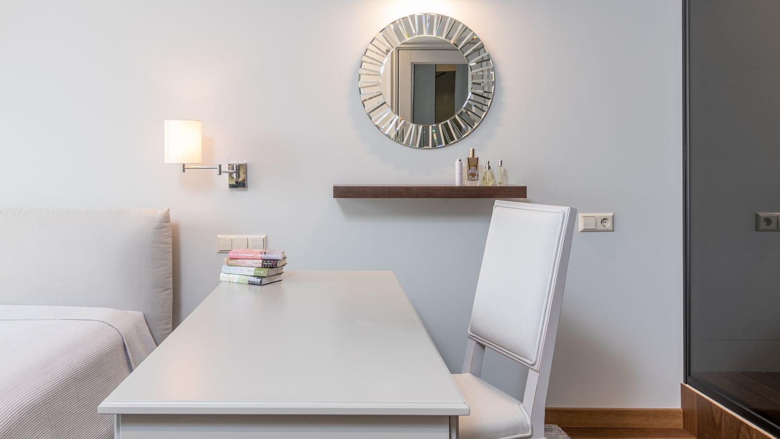 Bright bedroom workspace with organised storage and a wall mirror