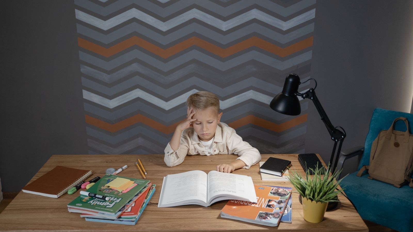 Kids homework desk with lamp books and school supplies organized