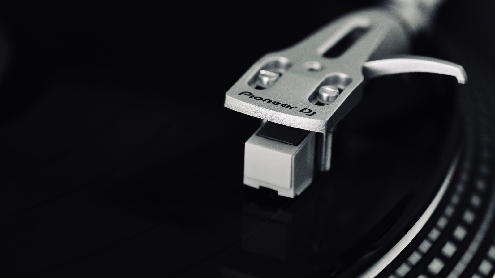 Turntable with tonearm and cartridge resting on a vinyl record