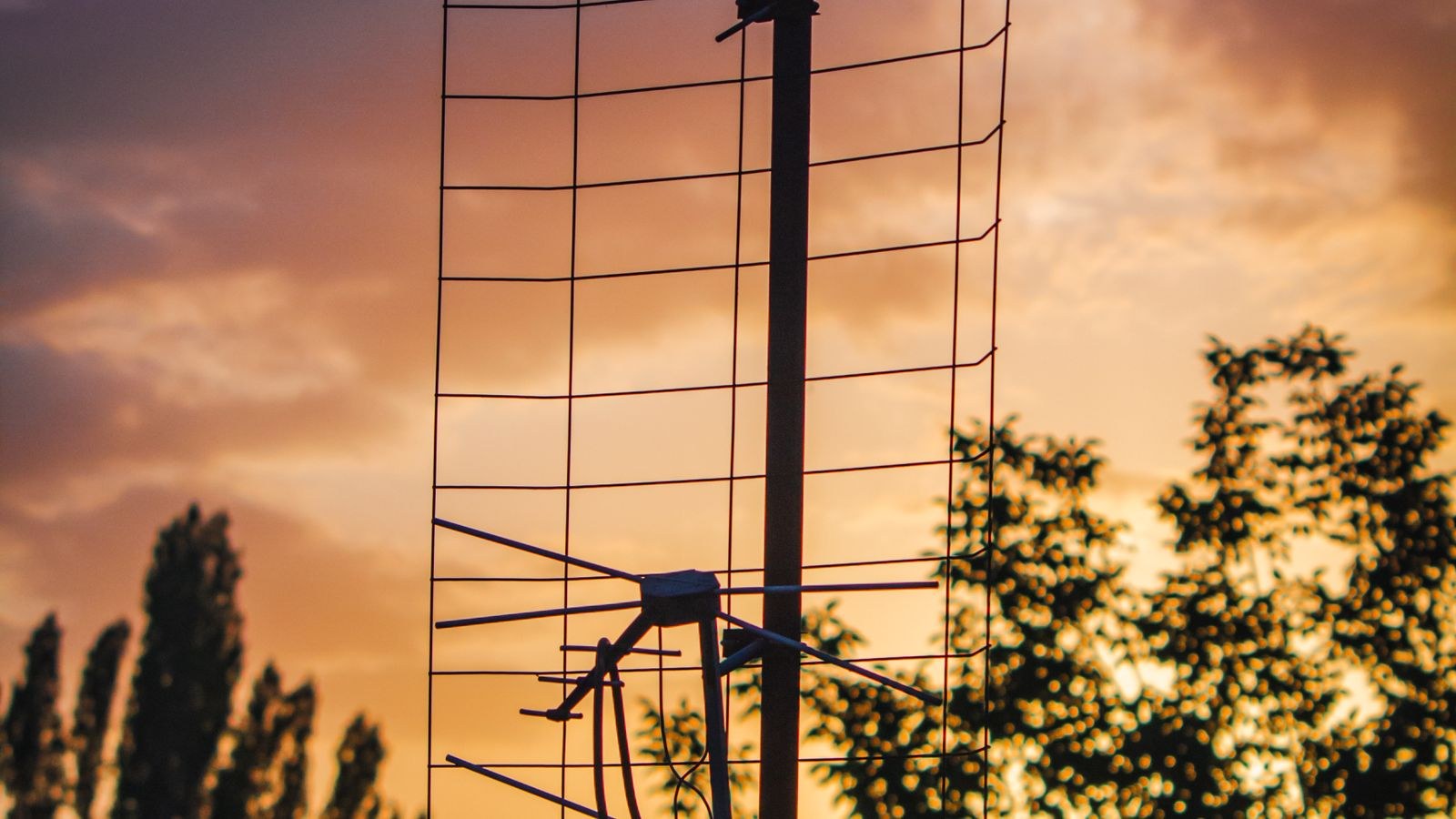 TV antenna silhouetted against the sky for free over the air channels