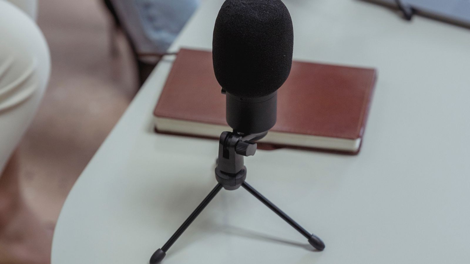 USB microphone on a boom arm at a streaming desk setup