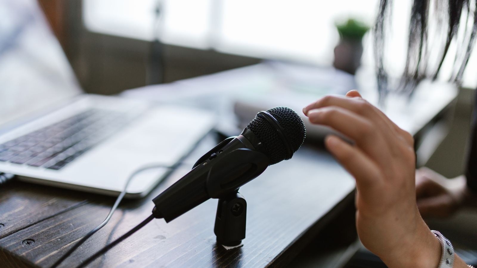 Streaming desk with microphone headphones and monitor for live broadcast