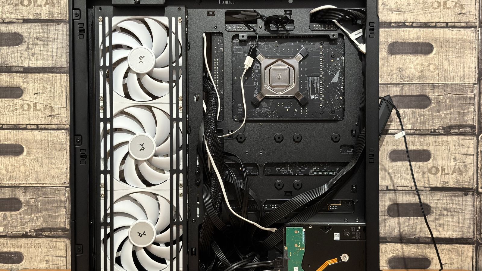 Open computer case interior showing fan mounts and internal wiring