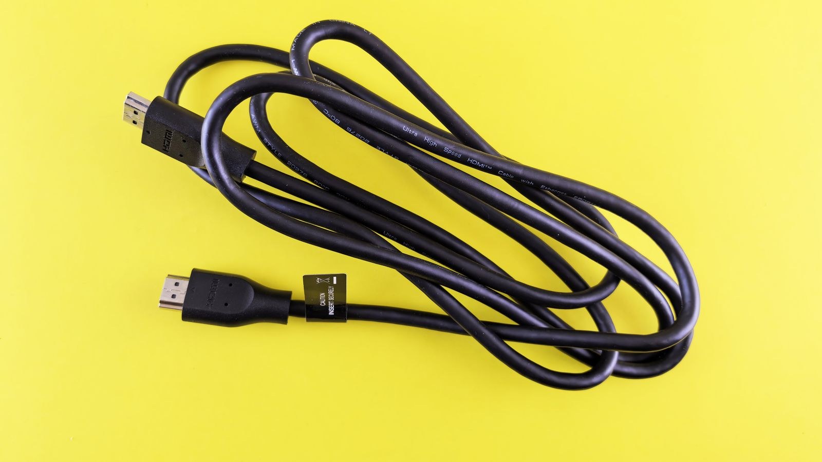 Coiled HDMI cable used to connect a TV to a soundbar over eARC