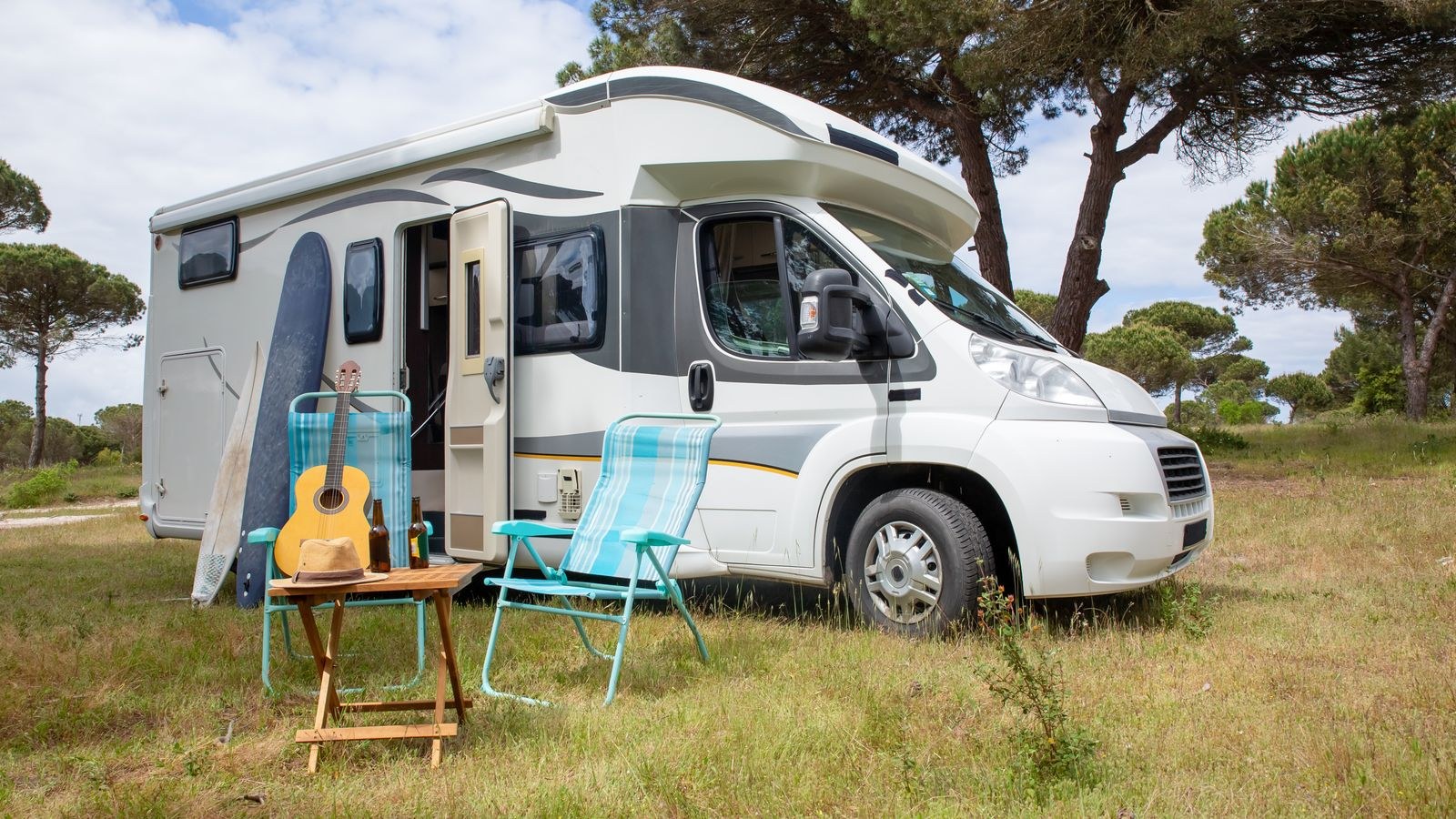 Interior of an RV set up as a mobile office with laptop and router