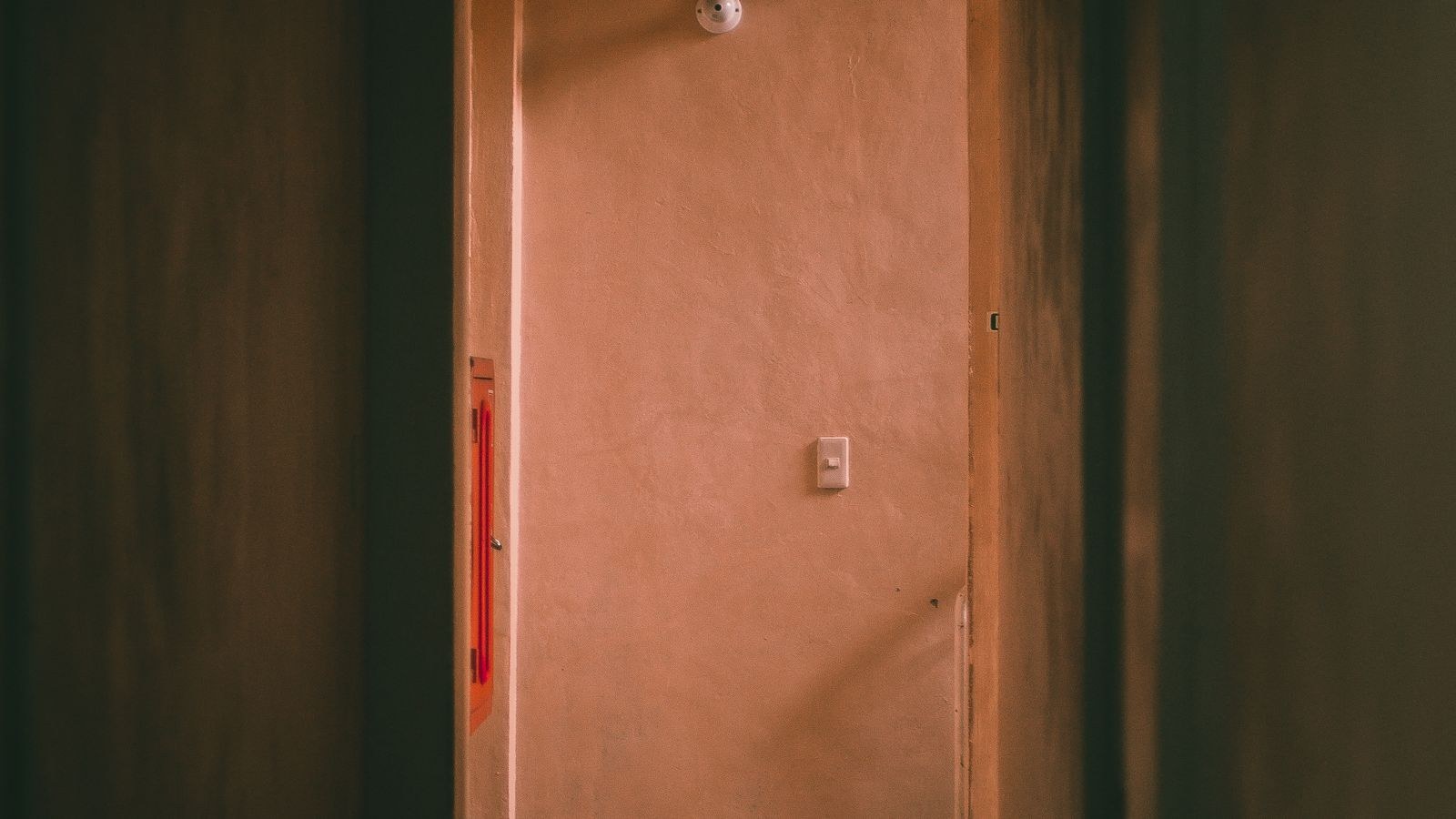 Smart lighting in a hallway adjusting brightness through motion sensor automation