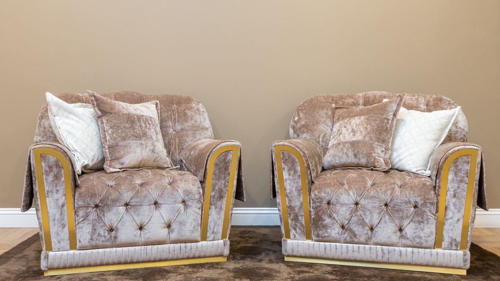 Two reupholstered velvet armchairs in a modern living room