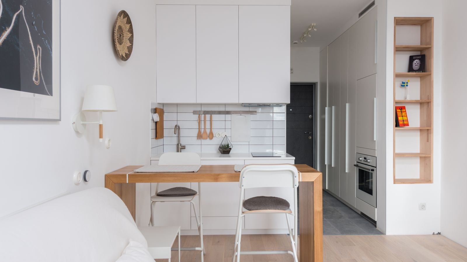 Wooden counter separating a kitchen zone from a small living room
