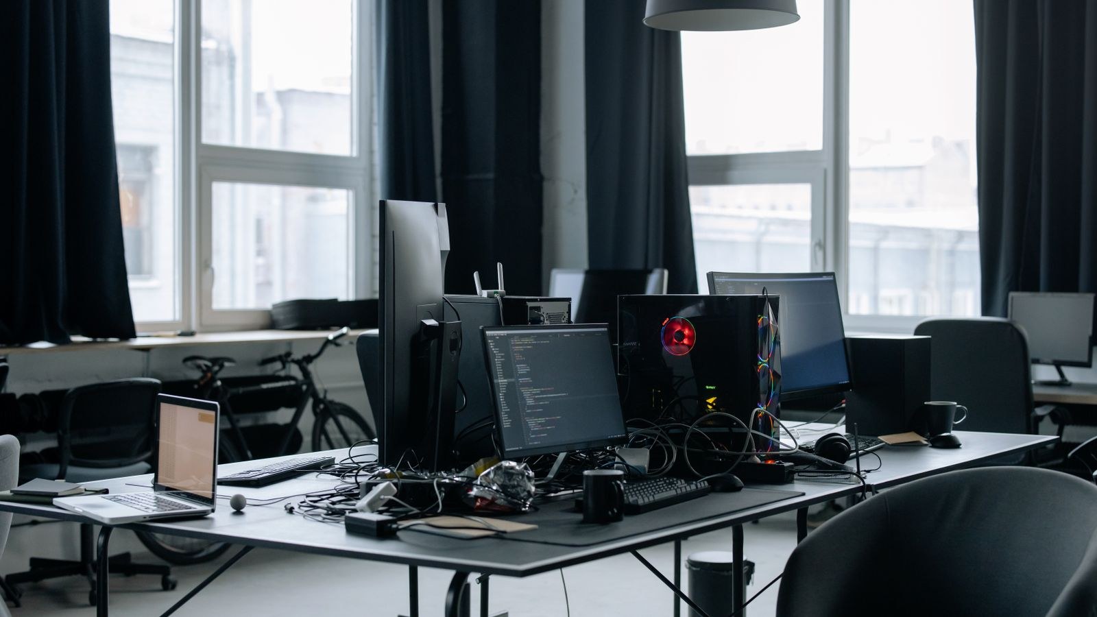 Small office workspace with multiple desks and computers connected to a business network