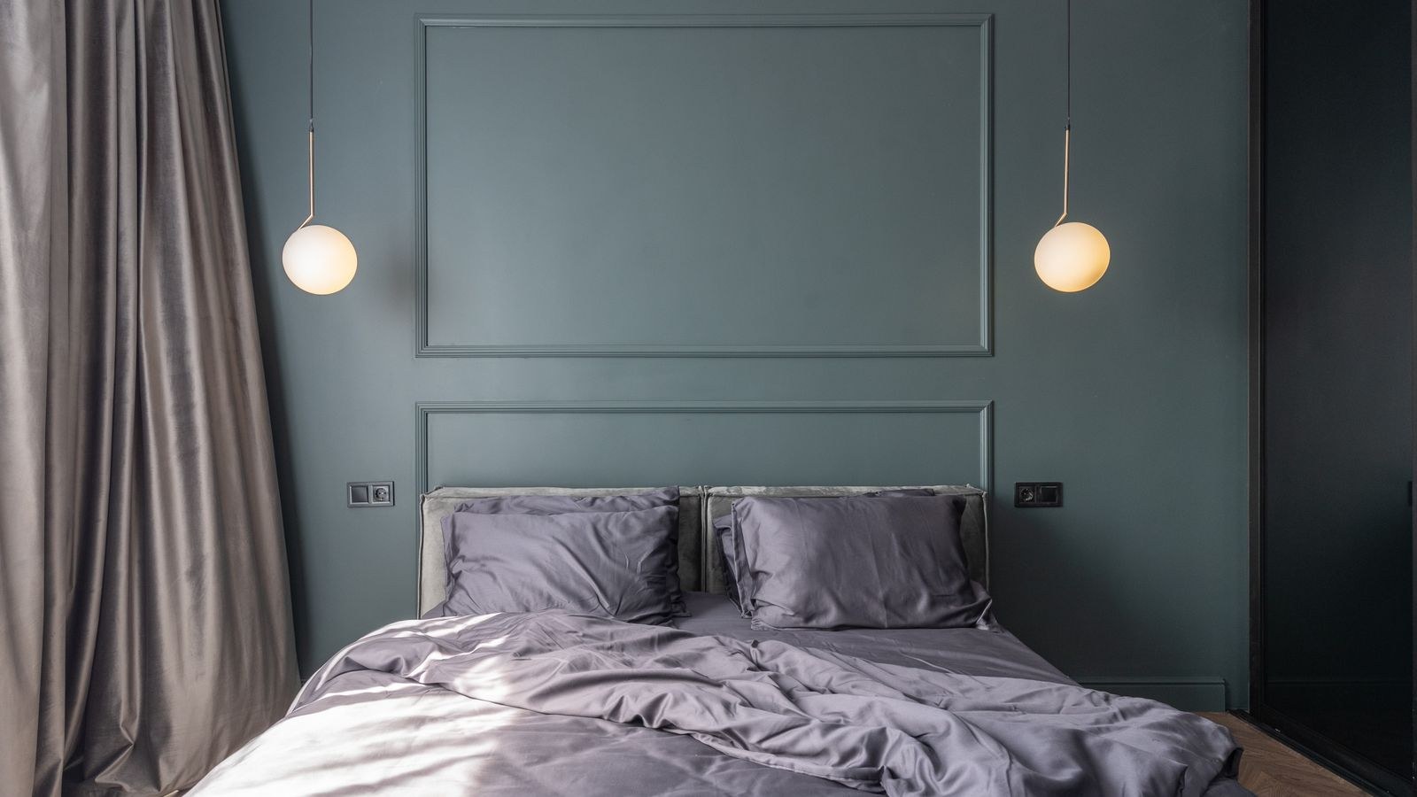Modern bedroom with automated curtains and warm dimmed smart lighting at sunrise
