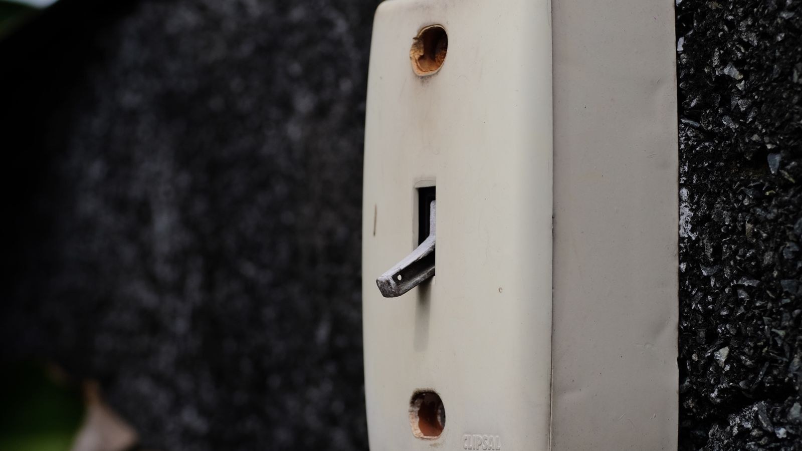 Person pressing a battery powered smart button controlling home lighting