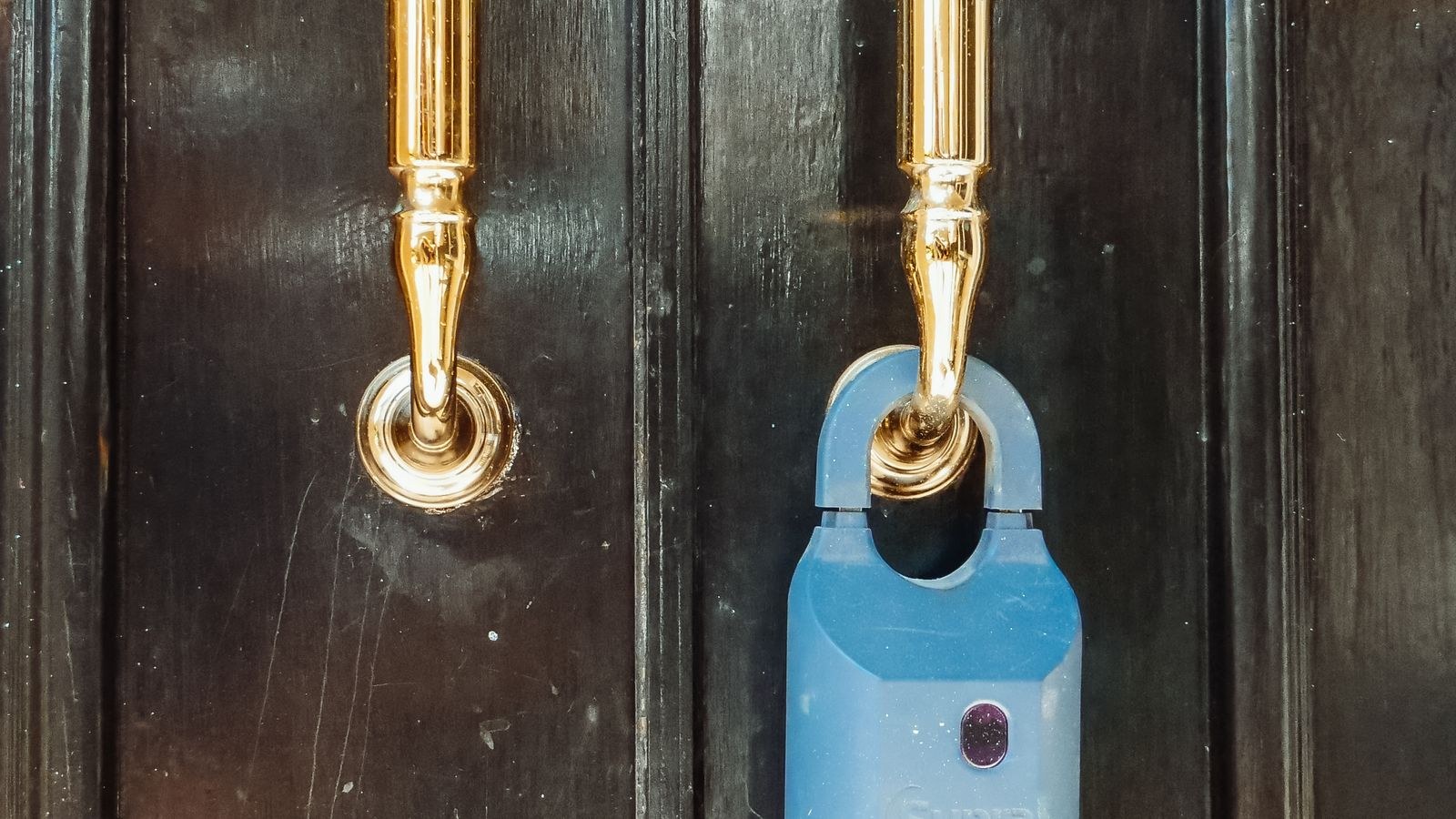 Rental property front door with a lockbox and modern entry hardware