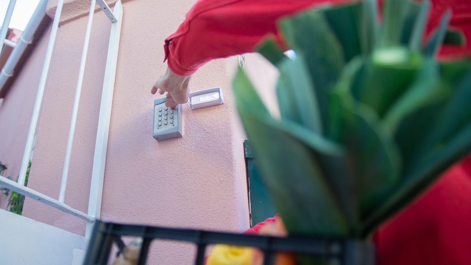 Person entering a code on an exterior keypad for keyless home entry