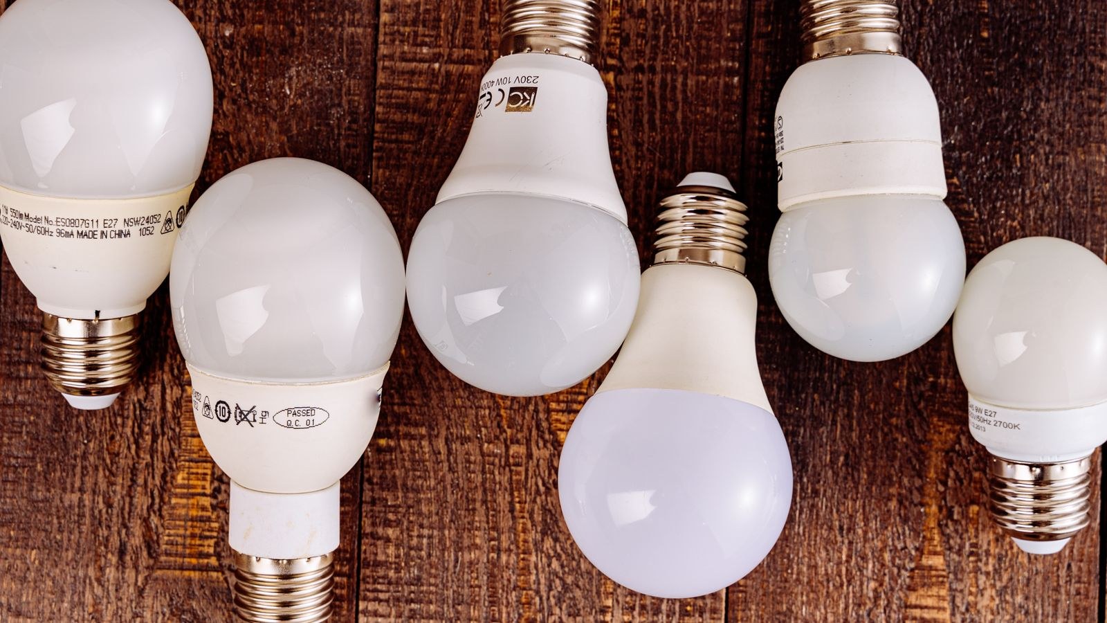 LED bulbs arranged on a wooden surface showing smart lighting choices