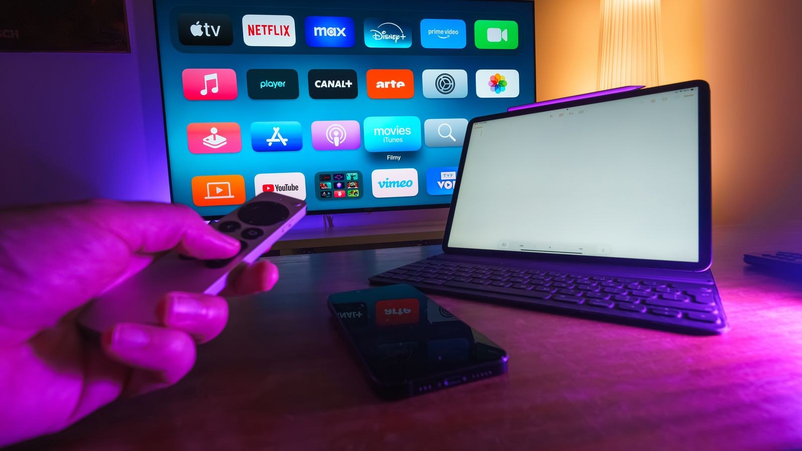 Streaming services displayed across a smart TV tablet and smartphone in a living room