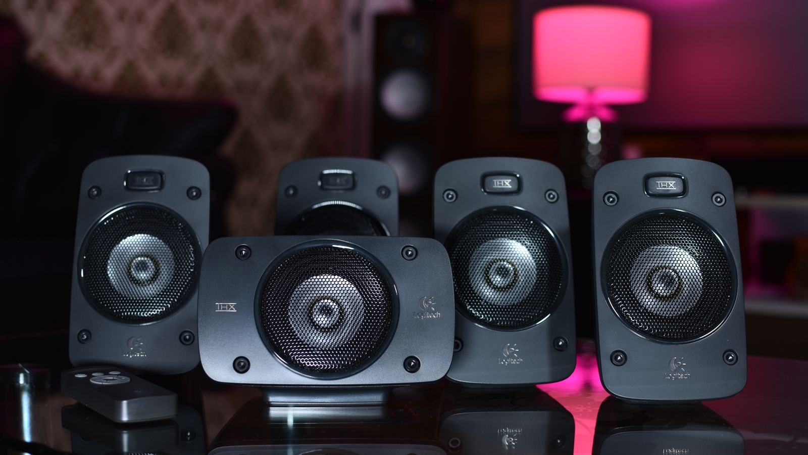 Close up of a surround sound speaker system with remote control in a modern home