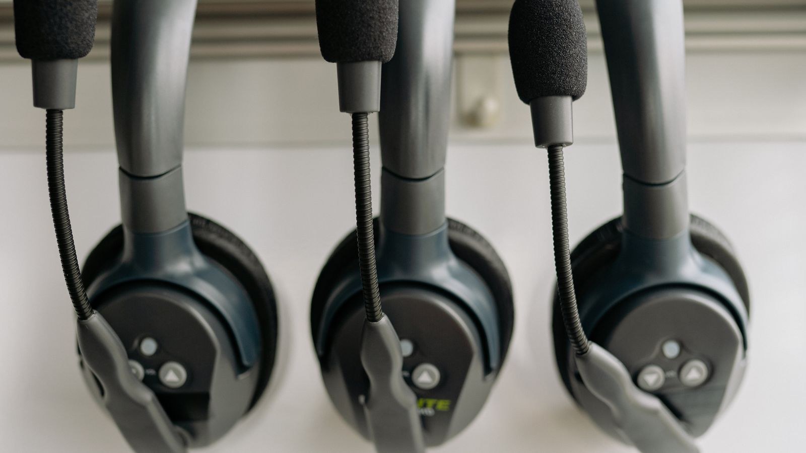 Gaming headset with virtual surround sound resting beside a keyboard