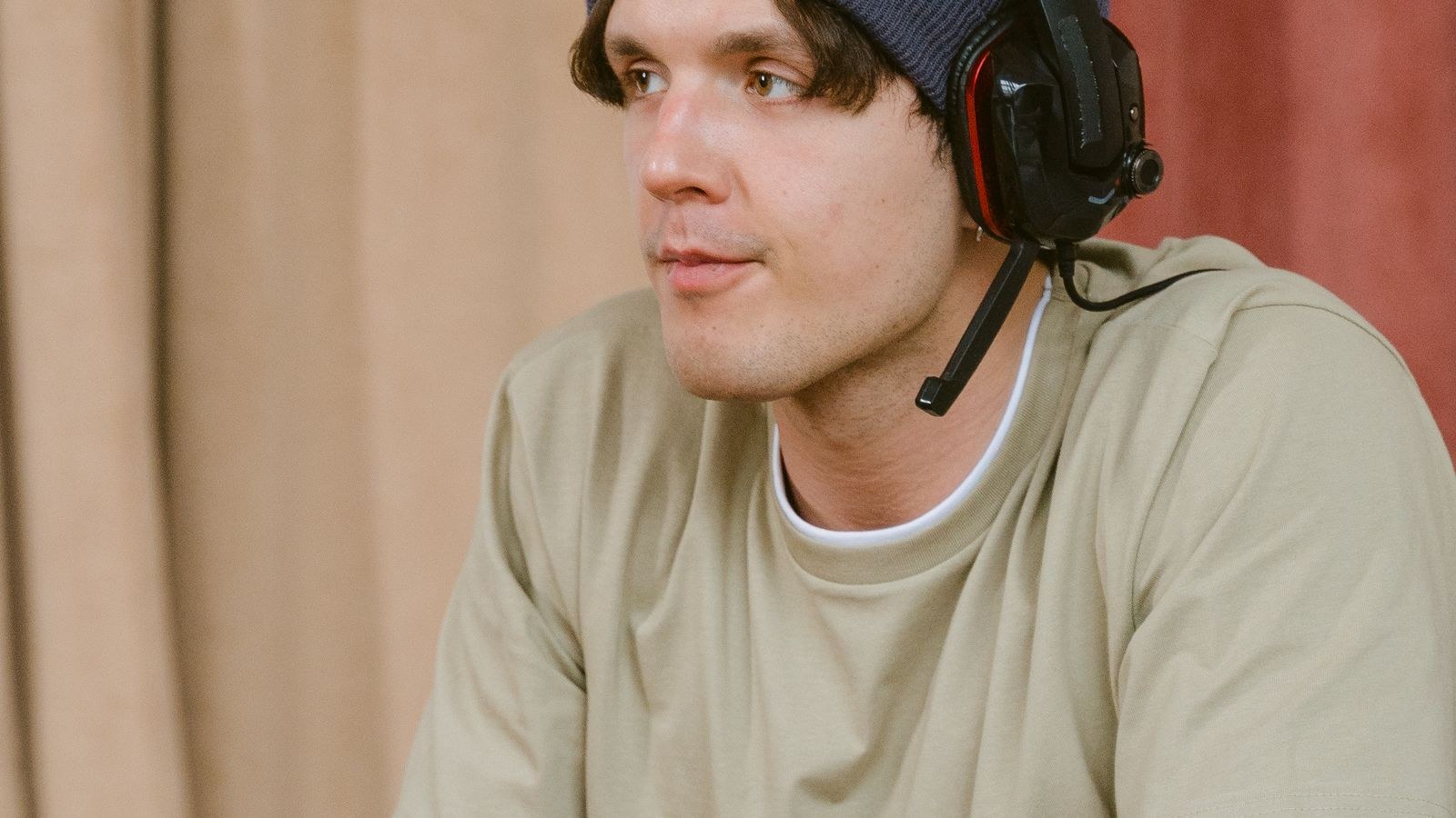 Player wearing surround sound headphones at a desktop gaming station