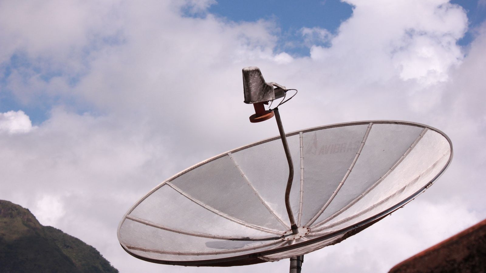 Satellite dish antenna against a clear sky providing rural home internet