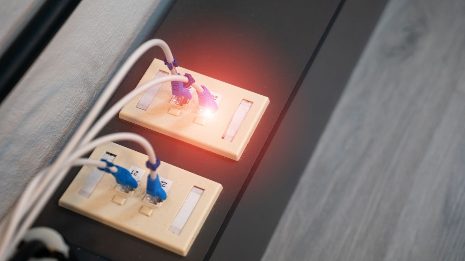 Ethernet ports with connected cables and illuminated LED indicators