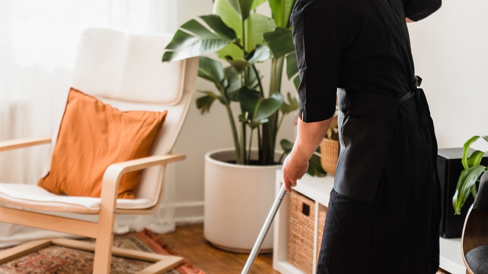 Sunlit room with hard flooring being mopped as part of a regular cleaning routine