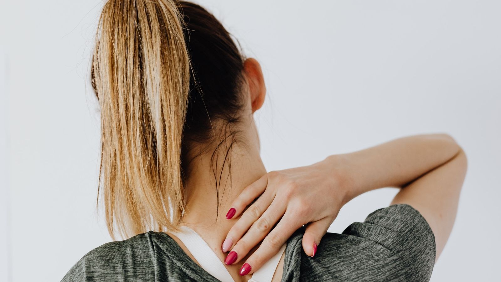 Seated person indicating a sore spot on the lower back and hip area from long sitting