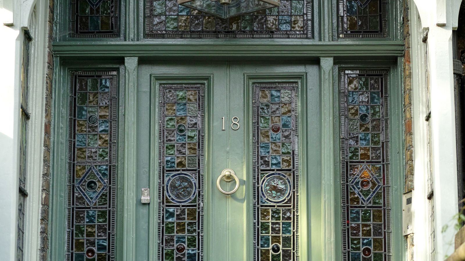 Close up of storm door handle and lock hardware on a house entrance