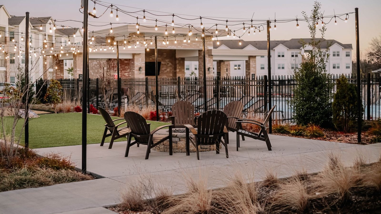 Outdoor patio lit by warm hanging string lights in the evening