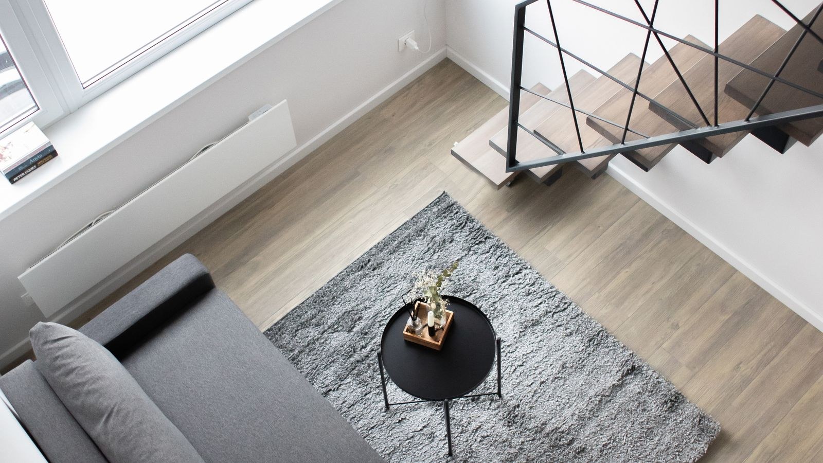 Overhead view of a stylish loft studio with zoned furniture arrangement