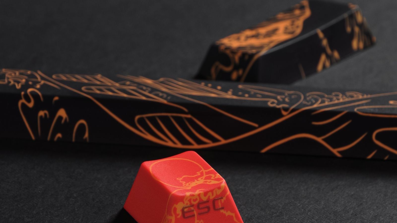 Custom keycap set with detailed designs including the escape key on a dark surface