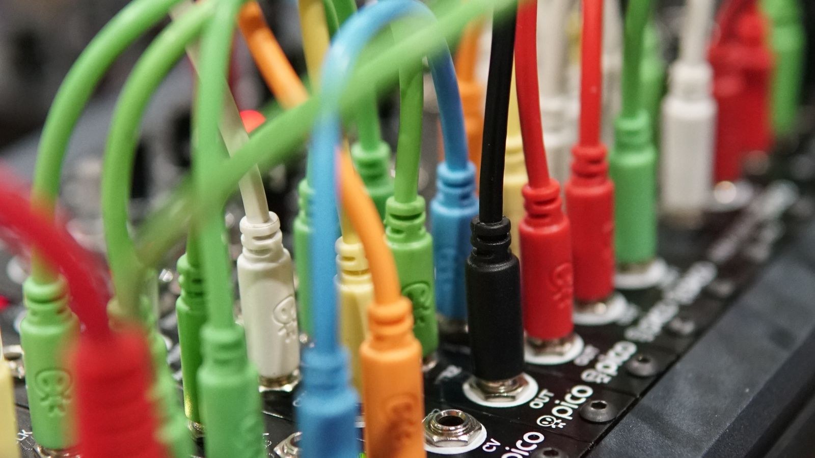 Close up of neatly organised audio cables plugged into equipment