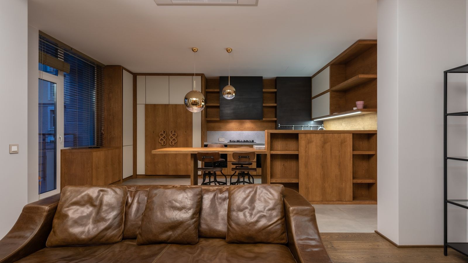 Comfortable leather sofa with pillows in a contemporary apartment interior