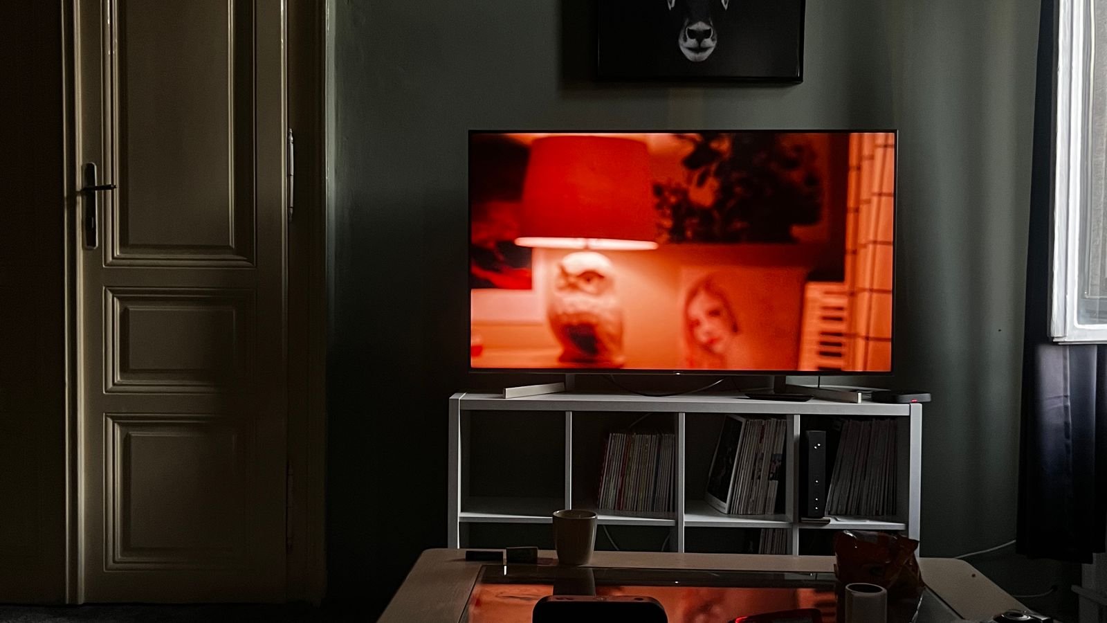 Television in a living room with ambient backlighting behind the screen