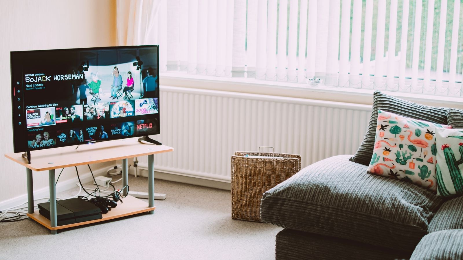 Living room sofa positioned in front of a large screen TV showing recommended seating distance