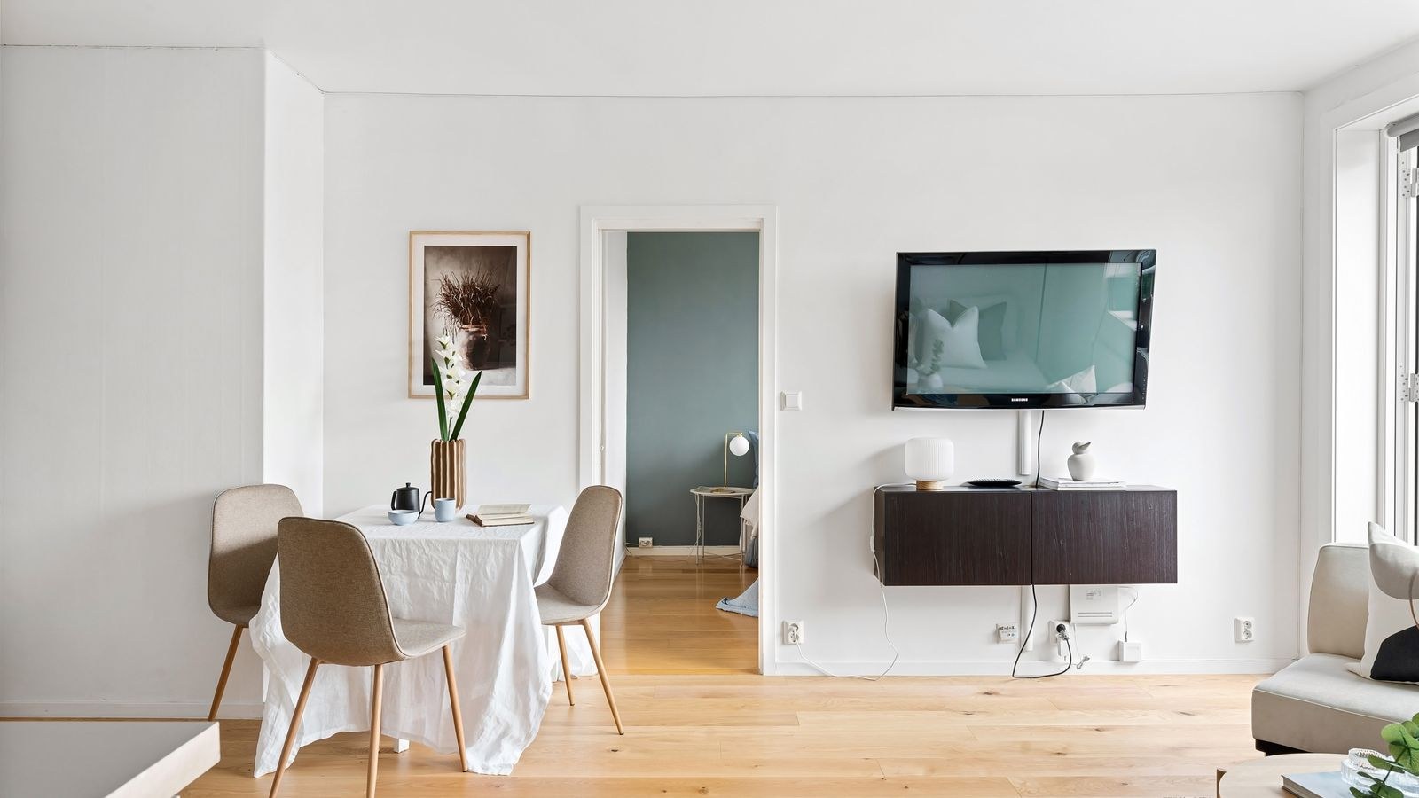 Minimalist living room with wall mounted television and hidden wiring