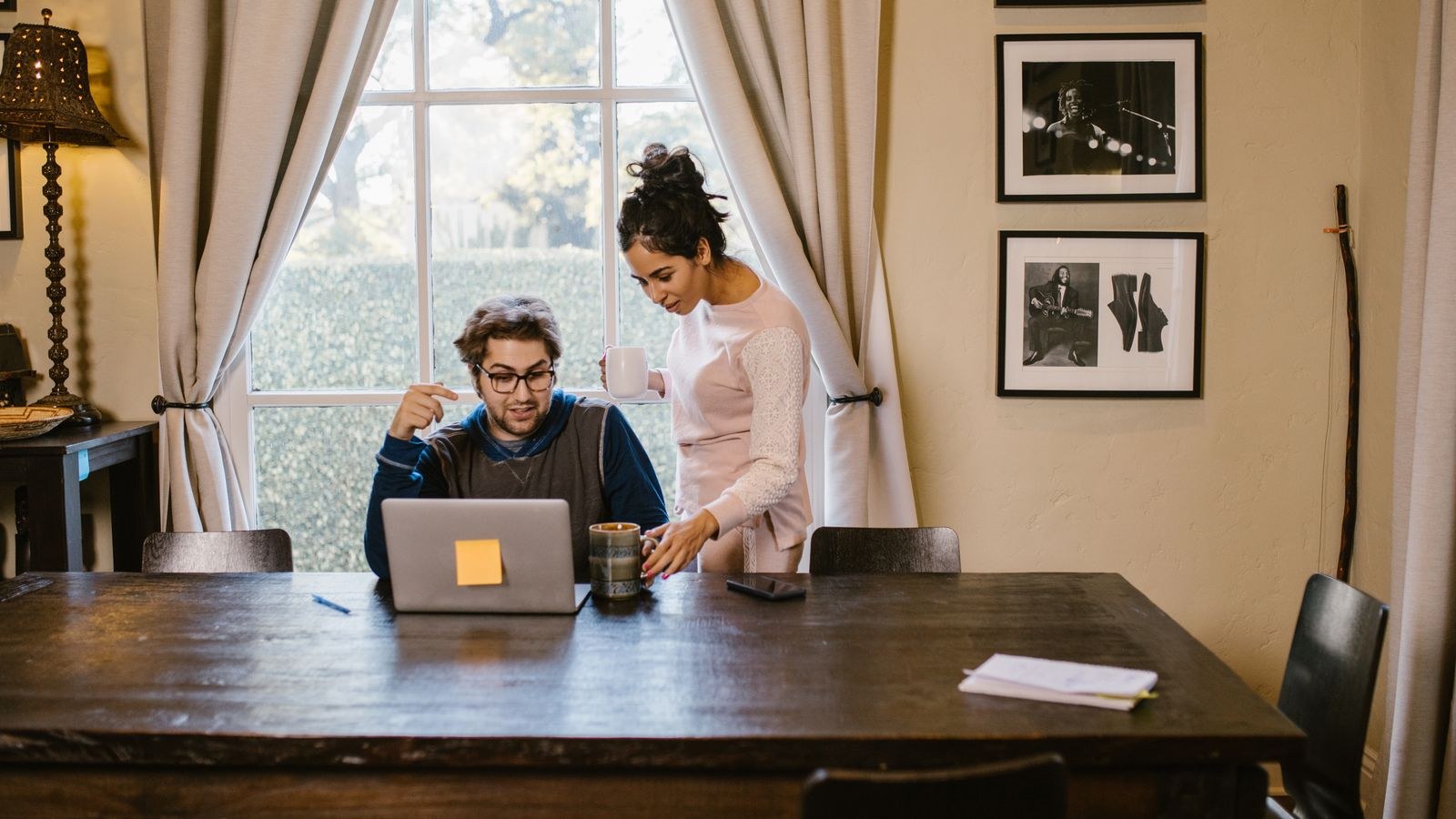 Shared home office desk layout with two laptop workstations side by side