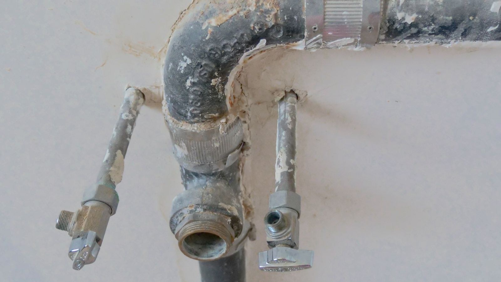 Under sink plumbing pipes and connections where a water filter system is installed