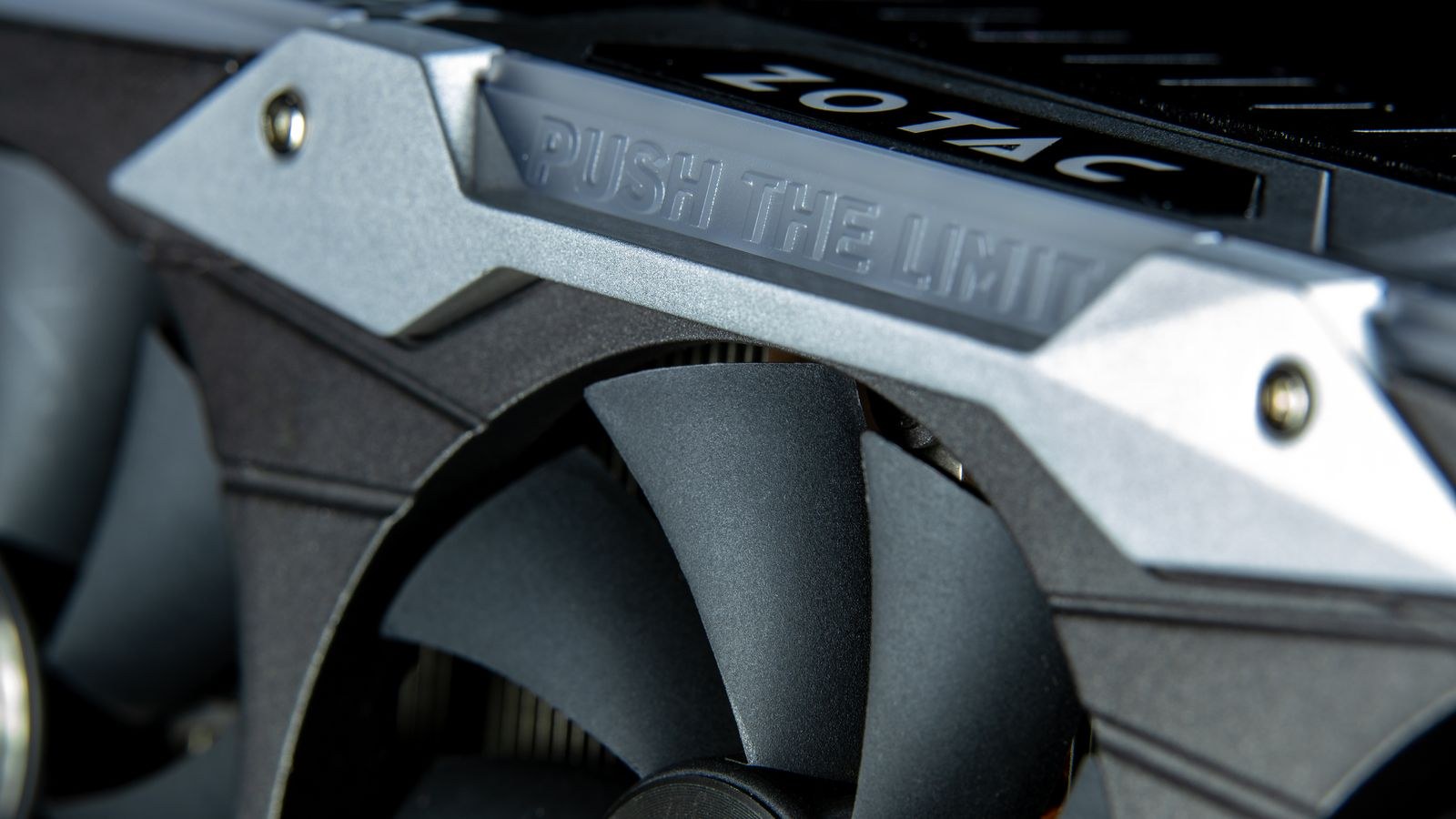 Close up of a graphics card with metal cooling fans and heatsink fins