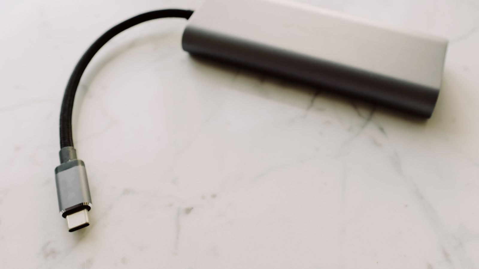 USB-C adapter and connector on a desk surface close up