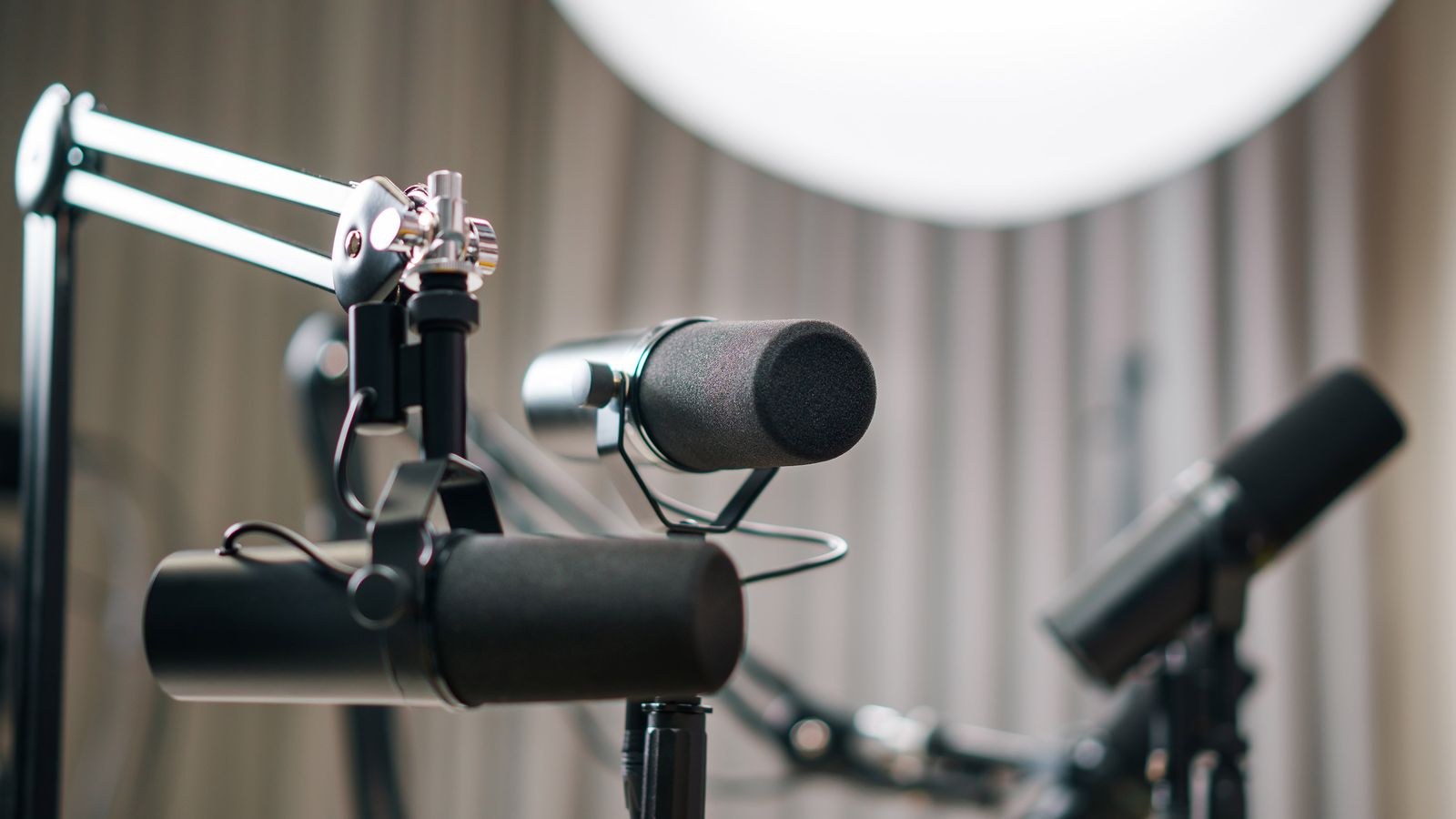 Dynamic microphones set up in a professional podcast recording studio