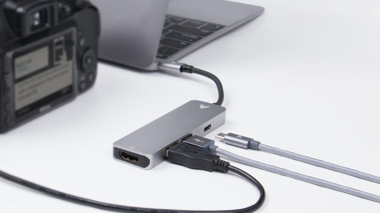 Laptop with camera and connected cables on a desk setup