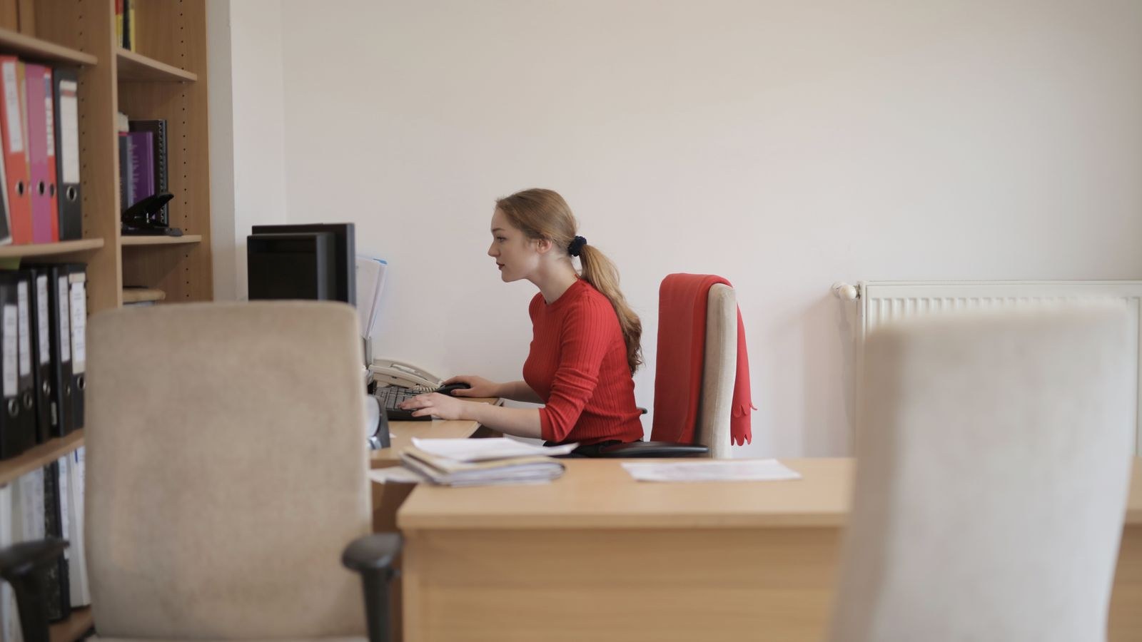 Ergonomic office chair and desk setup with feet supported at a comfortable height