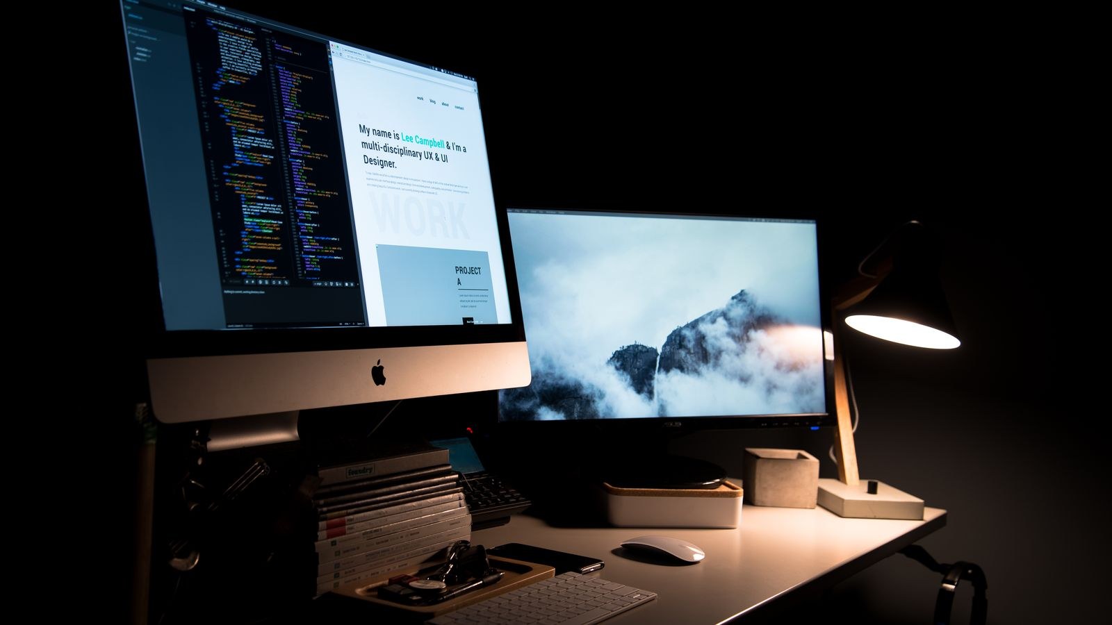 Clean workspace with dual monitors and a desk lamp providing balanced task lighting