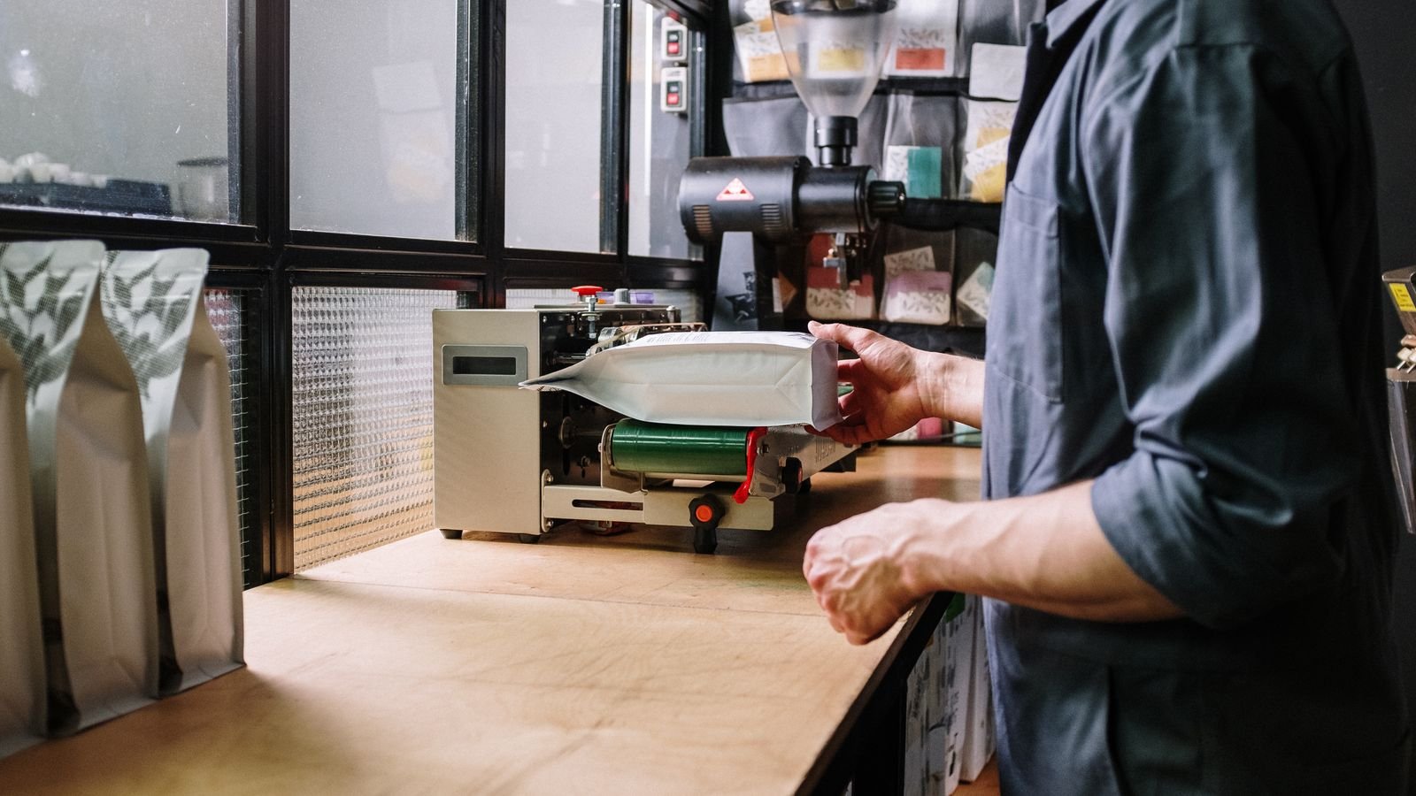 Countertop vacuum sealer machine sealing a bag of food on a kitchen worktop