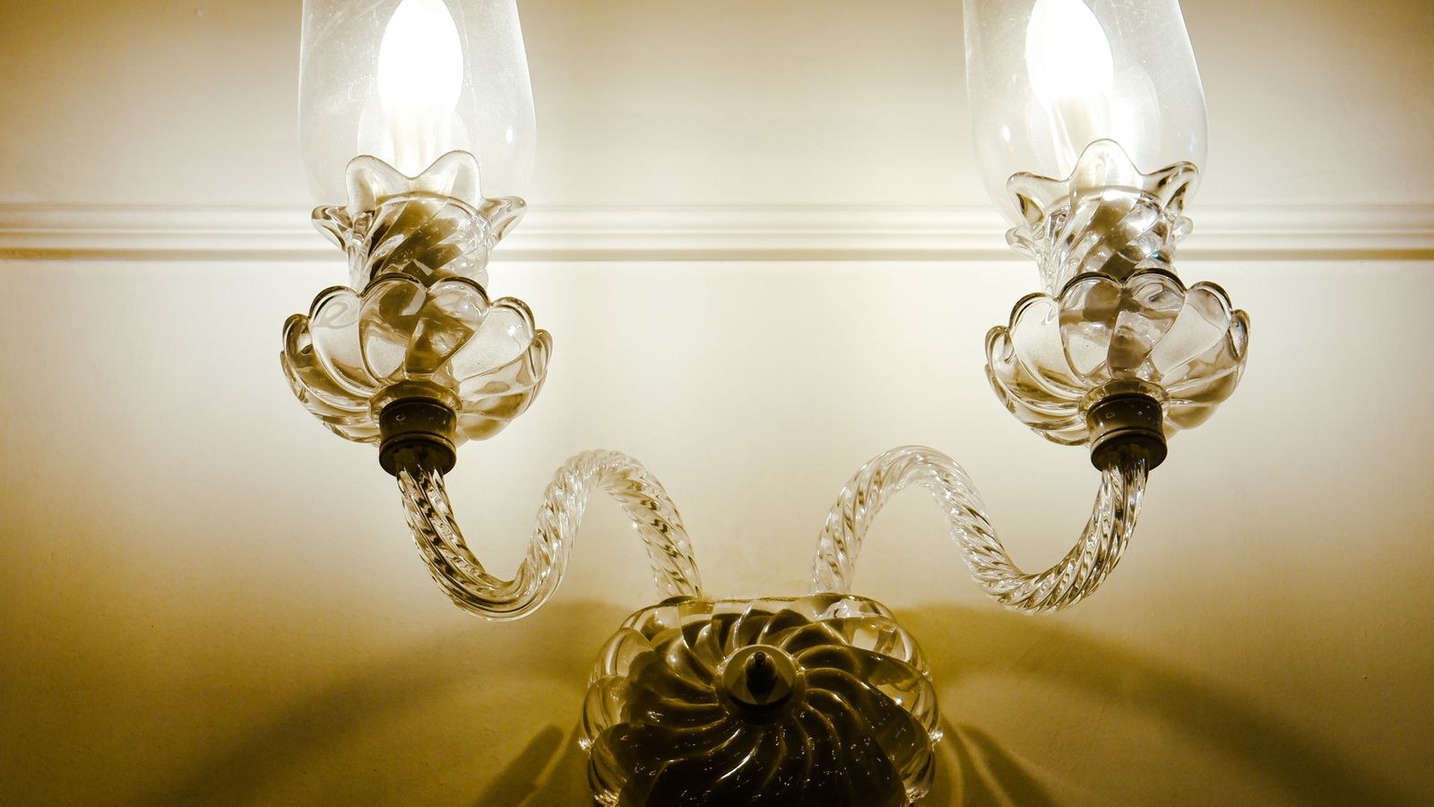Pair of illuminated wall sconces adding warm accent light to a decorated interior