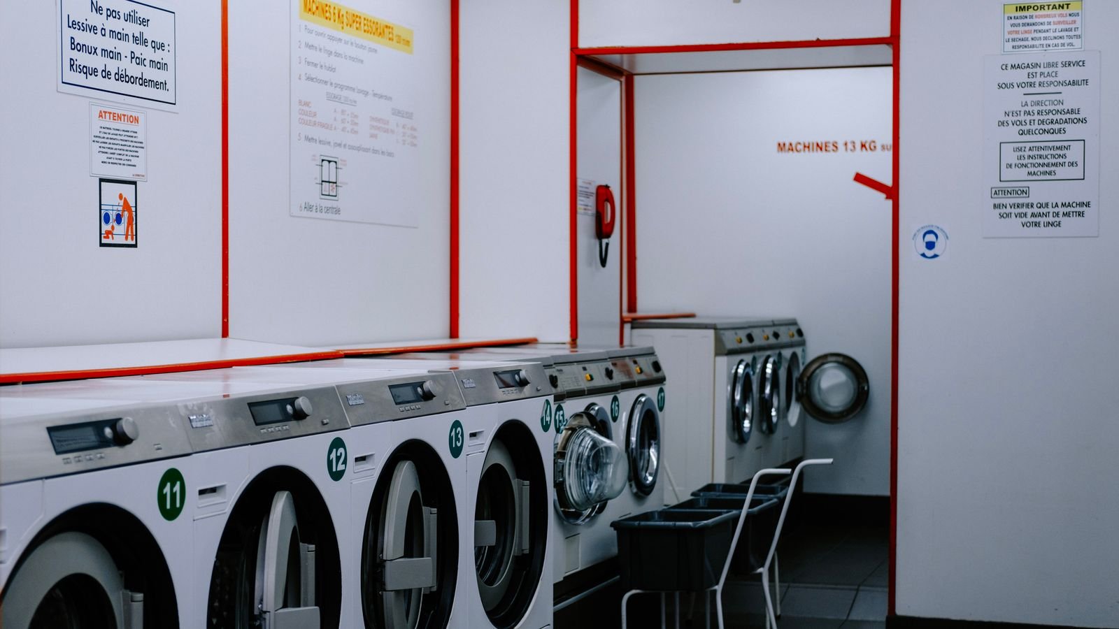 Front loading washing machine and dryer stacked in a compact utility space