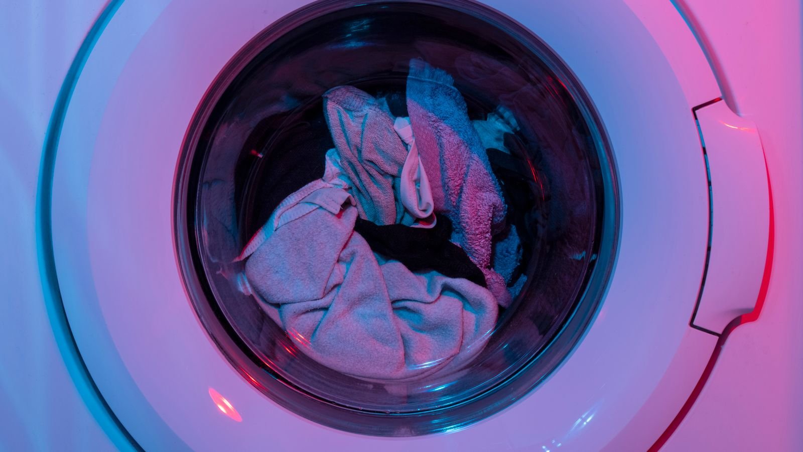 Laundry detergent and cleaning products beside a washing machine