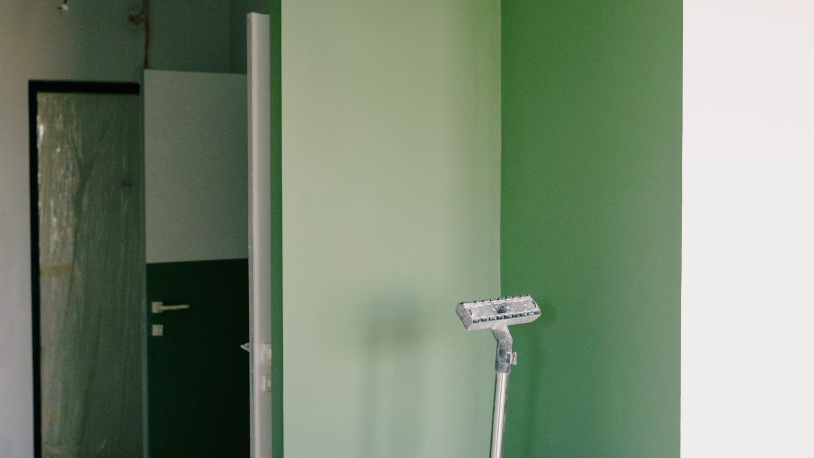 Wet dry vacuum standing in the corner of a room during a home renovation project
